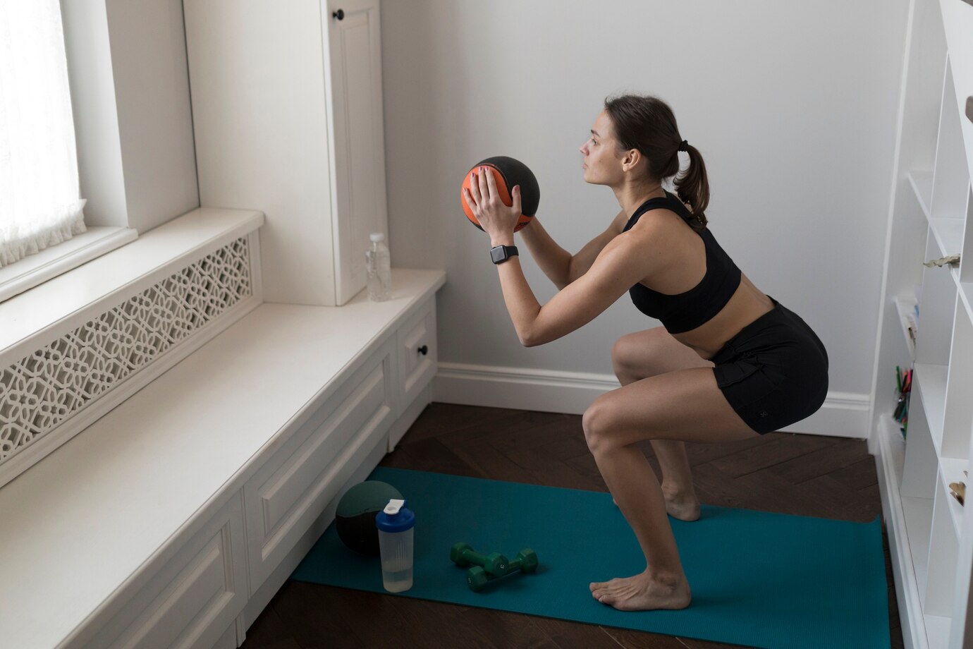 photo of woman squating with a ball