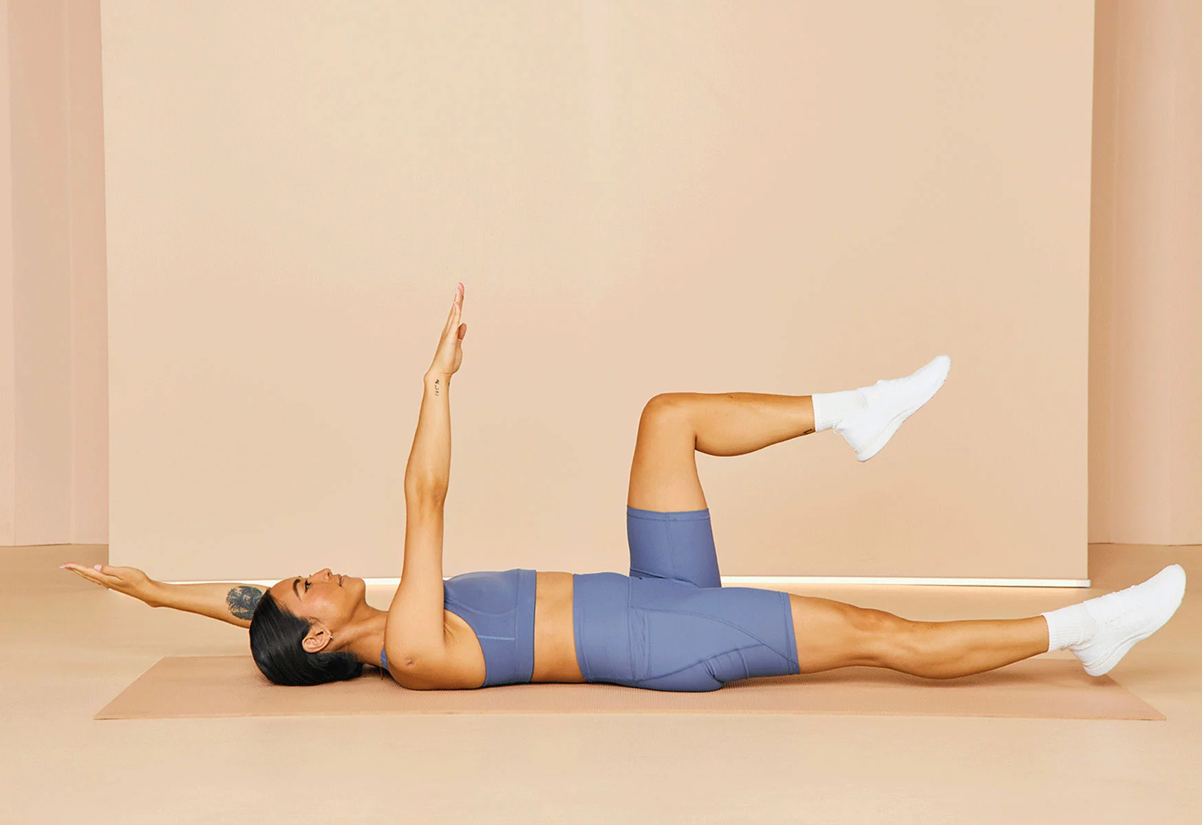 woman doing dead bug exercise